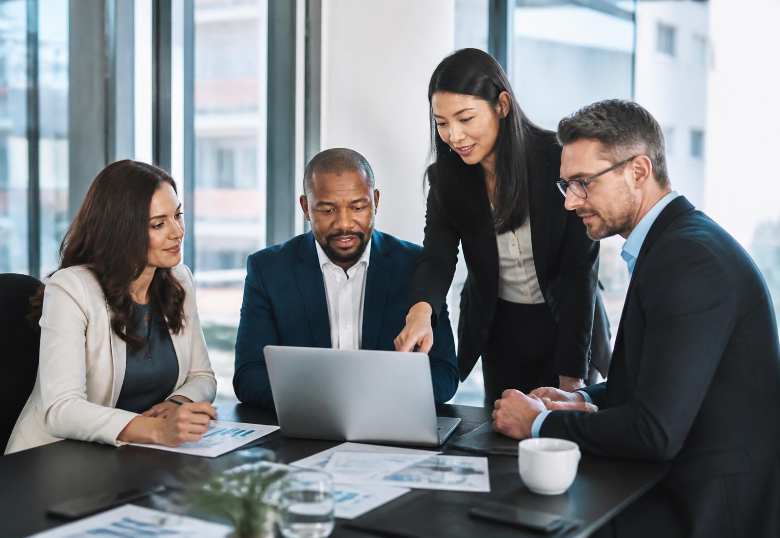 Management consultants reviewing business performance charts with a client team